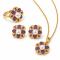 Purple enamel flower jewelry set on white — pendant necklace, stud earrings and ring with freshwater pearl centres in gold