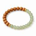 Sandalwood and green jade bead bracelet with gold lantern spacers, on white