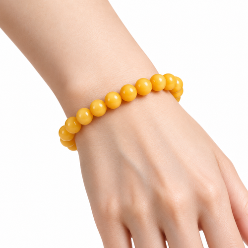 Butter-yellow beeswax amber bracelet worn on the wrist