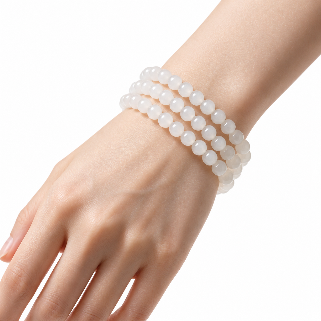 White Hetian jade triple-wrap bracelet worn on the wrist