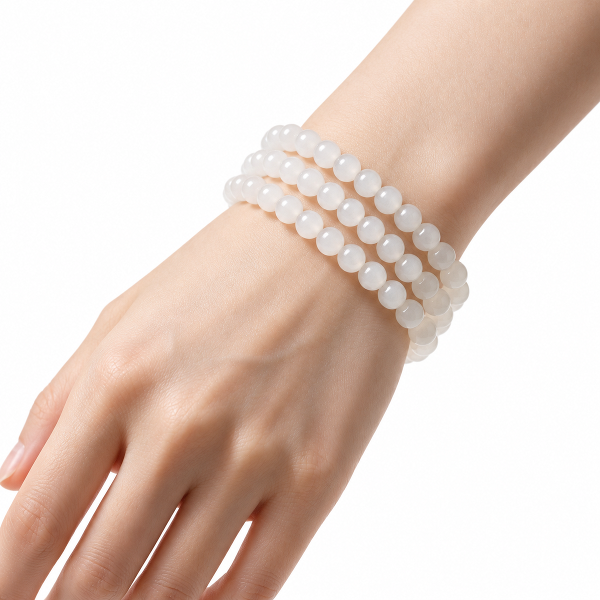 White Hetian jade triple-wrap bracelet worn on the wrist