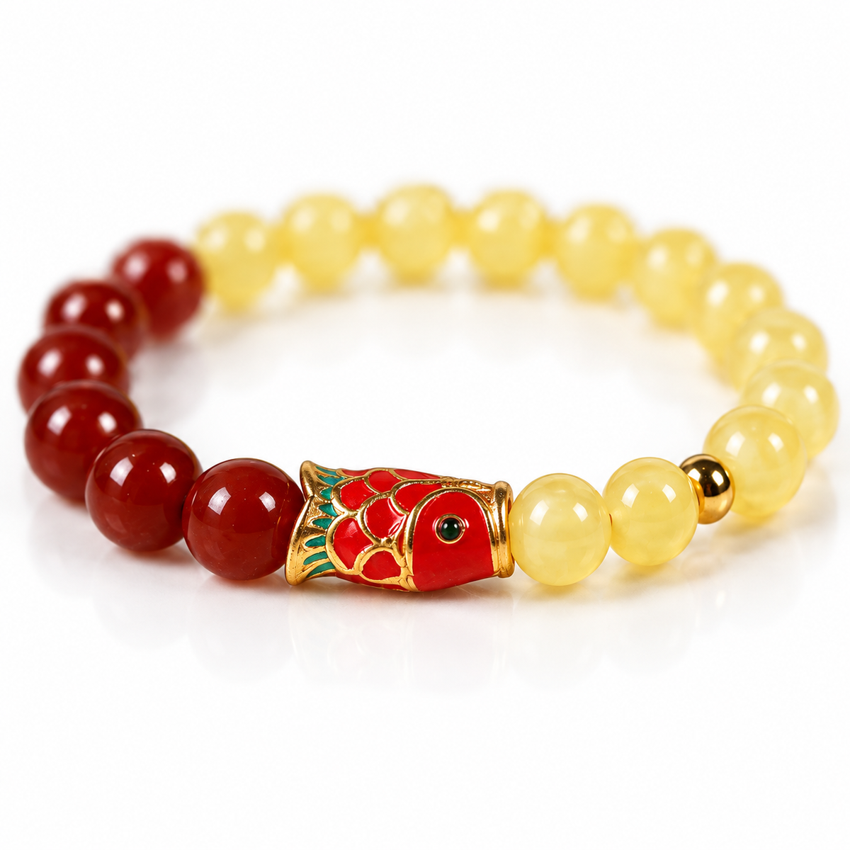 Macro detail of the enamelled koi fish charm between amber and red agate beads