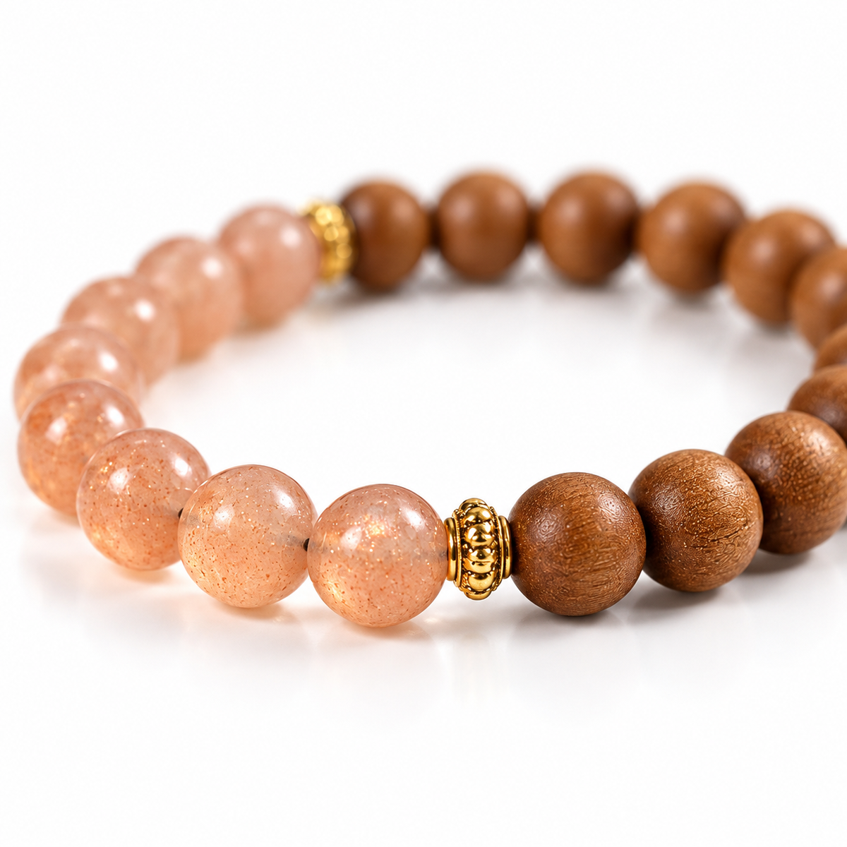 Macro detail of peach sunstone beads showing their soft shimmer beside sandalwood beads