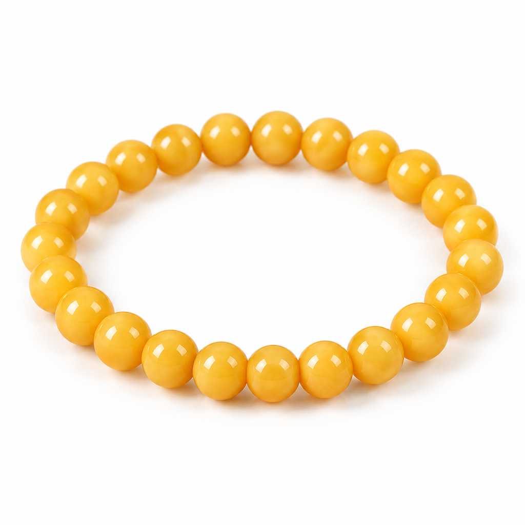 Butter-yellow beeswax amber bracelet arranged on white to show bead size and strand