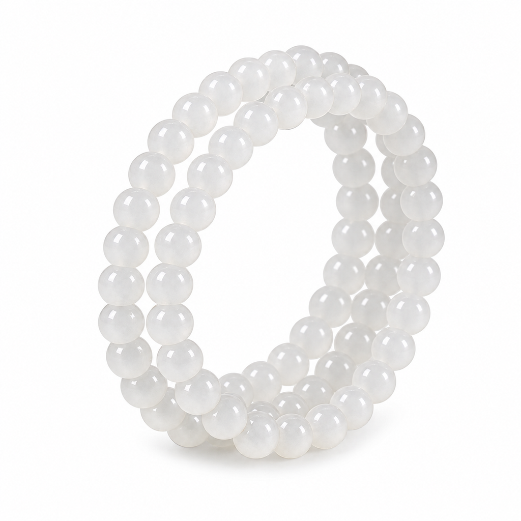 White Hetian jade triple-wrap bracelet laid out on white to show the three wraps