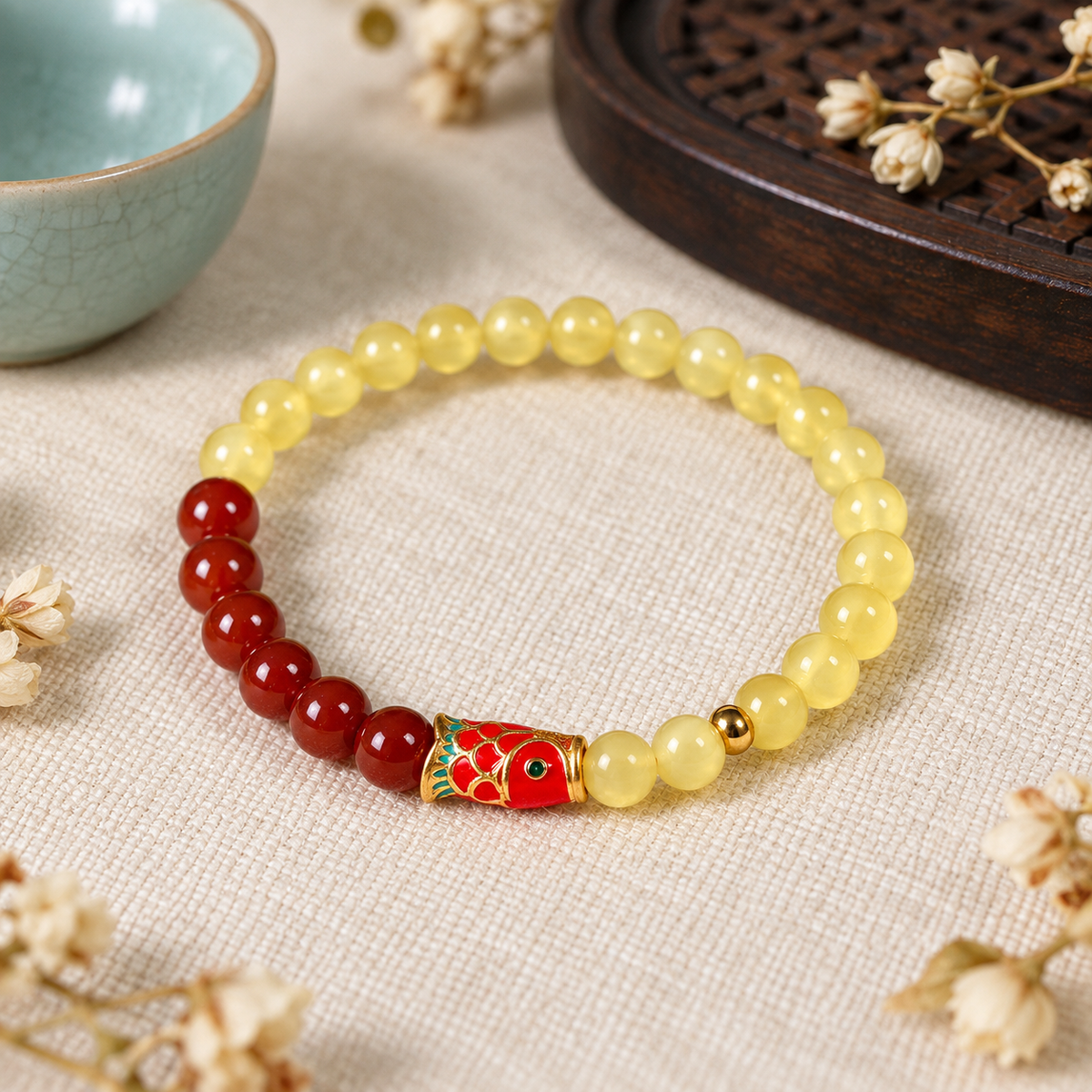 Koi charm amber and red agate bracelet styled in a lifestyle scene