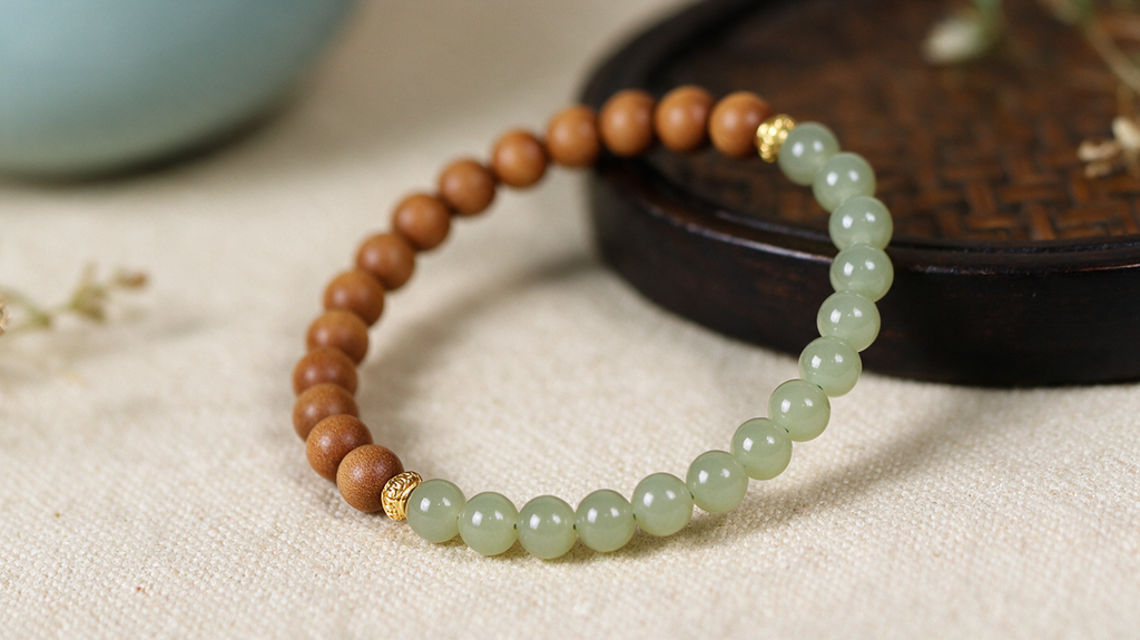 Sandalwood and green jade bracelet styled in a calm lifestyle scene